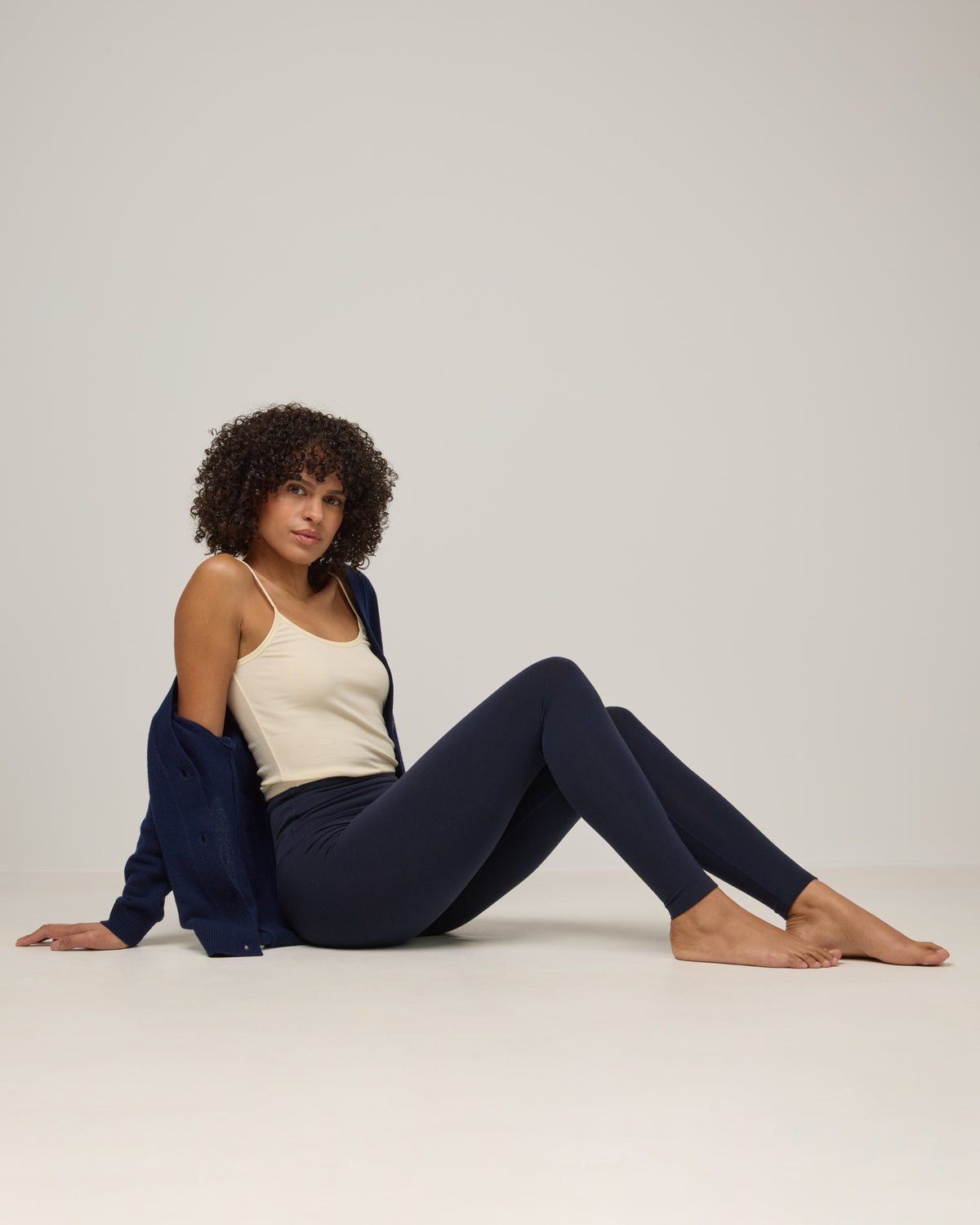 Model wearing Summit Legging in Navy. Summit Legging is a merino wool legging available in sizes XS-3X Regular, S-XXL Long.
