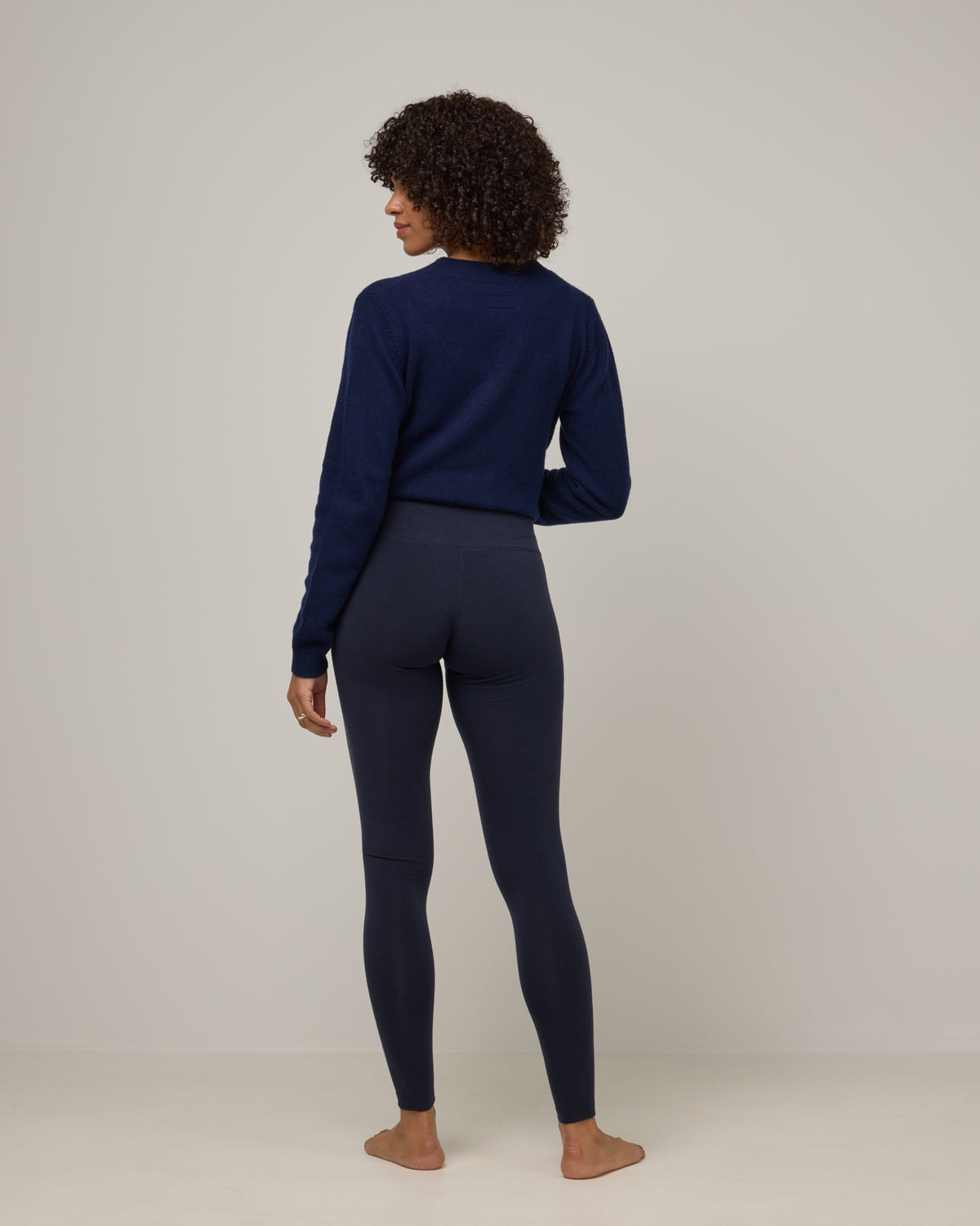 Model wearing Summit Legging in Navy. Summit Legging is a merino wool legging available in sizes XS-3X Regular, S-XXL Long.