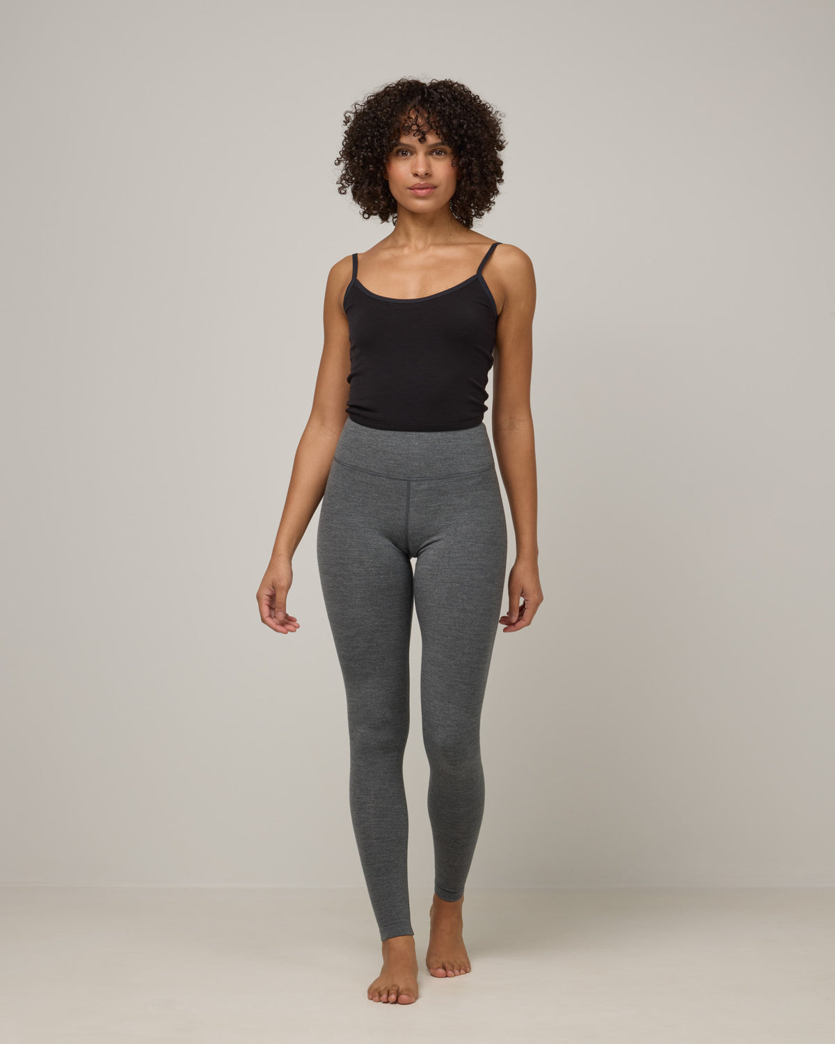 Model wearing Summit Legging in Charcoal Heather. Summit Legging is a merino wool legging available in sizes XS-3X Regular, S-XXL Long.