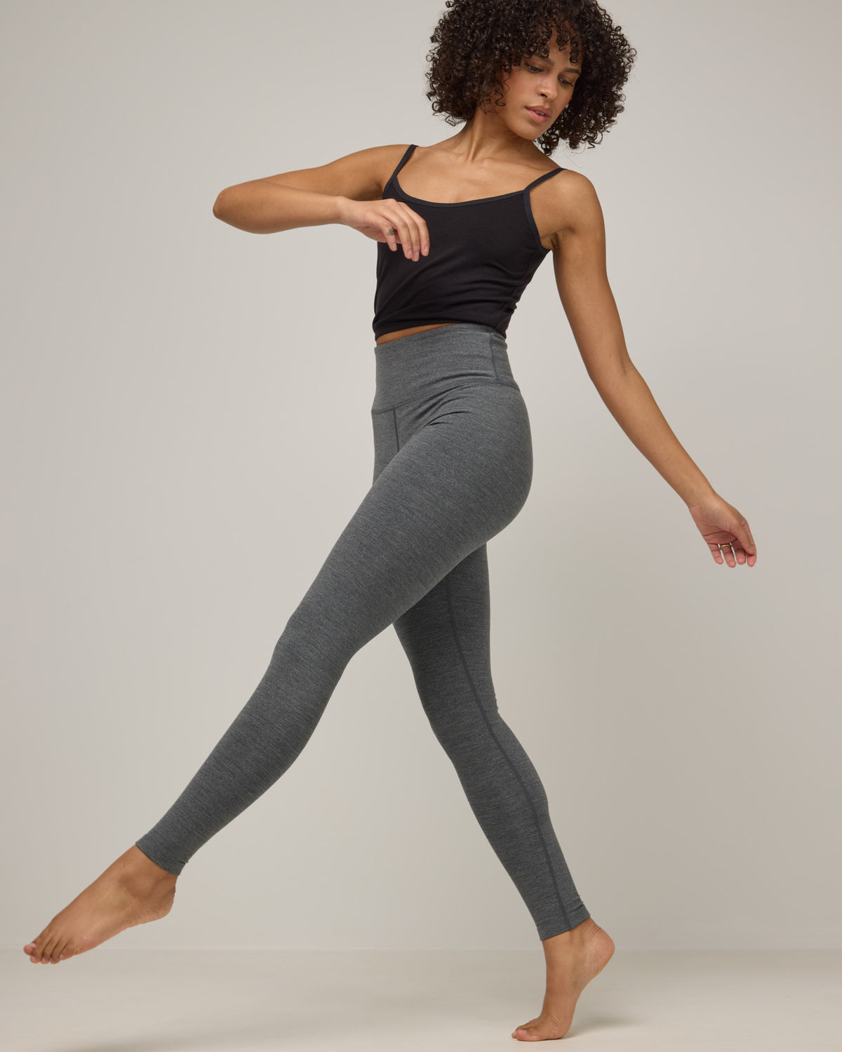 Model wearing Summit Legging in Charcoal Heather. Summit Legging is a merino wool legging available in sizes XS-3X Regular, S-XXL Long.