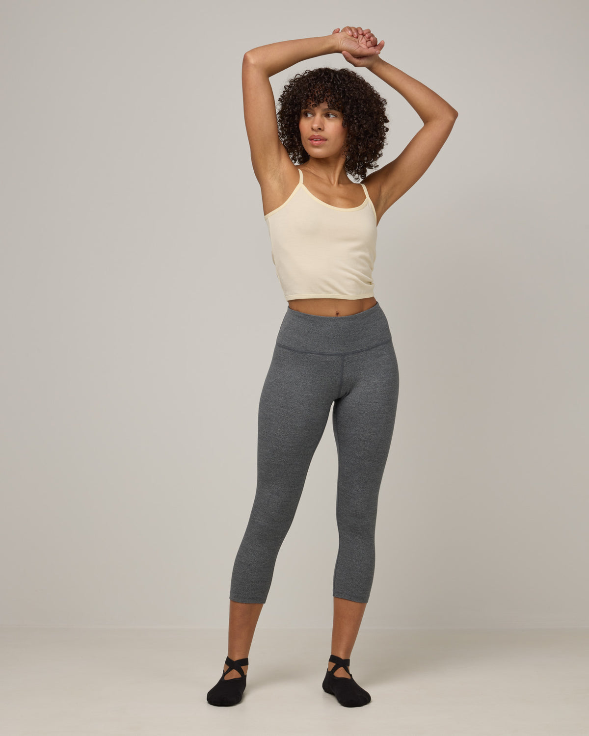 Model wearing Summit Crop Legging in Charcoal Heather. Summit Crop Legging is a merino wool legging available in sizes XS-3X.