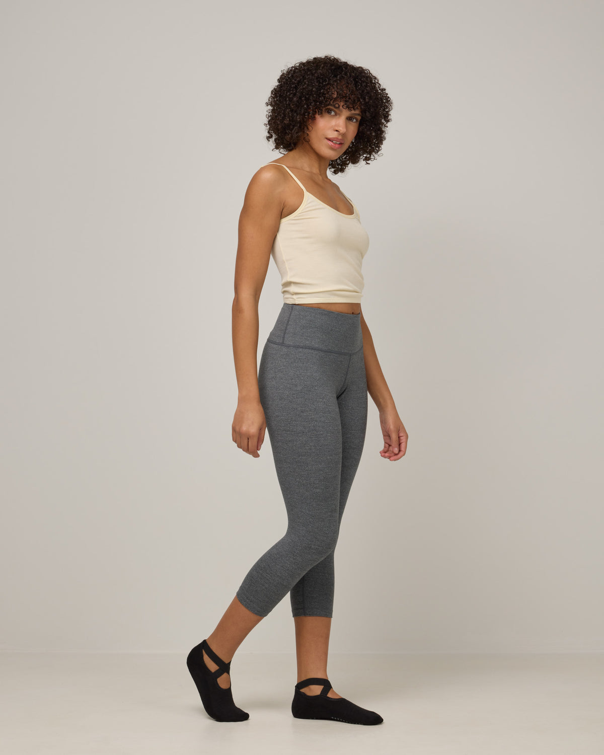 Model wearing Summit Crop Legging in Charcoal Heather. Summit Crop Legging is a merino wool legging available in sizes XS-3X.