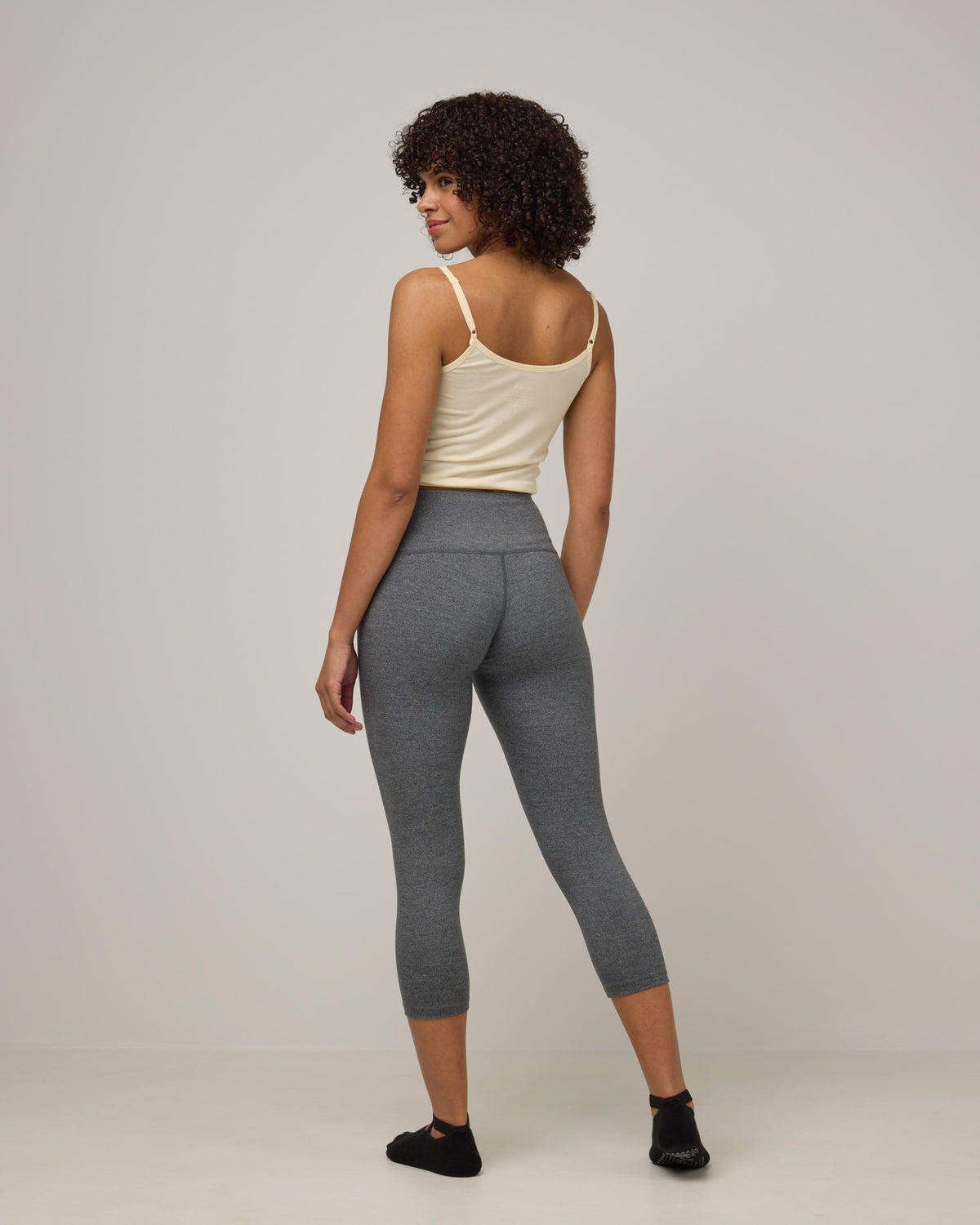 Model wearing Summit Crop Legging in Charcoal Heather. Summit Crop Legging is a merino wool legging available in sizes XS-3X.