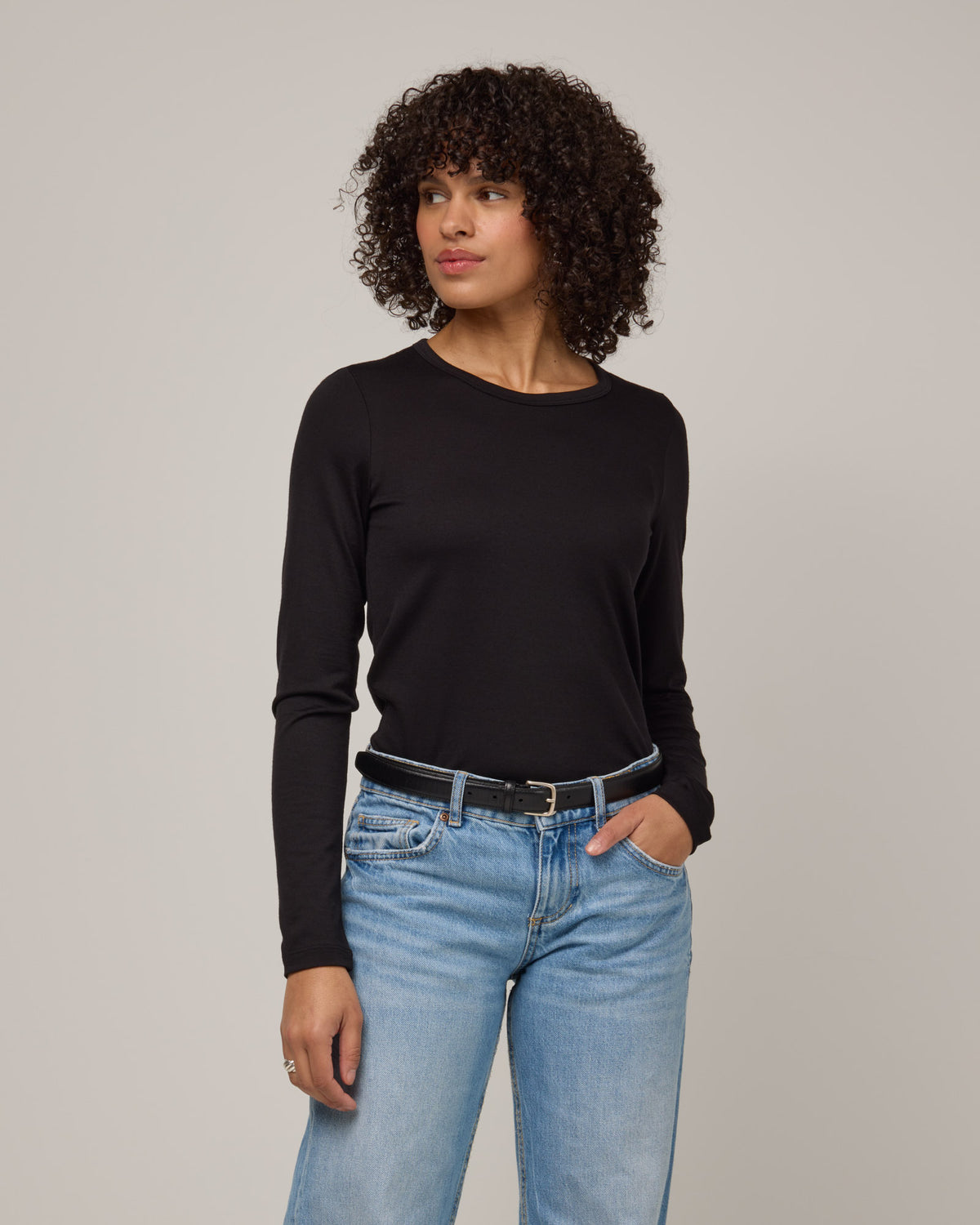 Model wearing Sloan Signature Fitted Tee in Black. Sloan Signature Fitted Tee is a merino wool long sleeve, crew neck, slim fit tee available in sizes XS-3X.