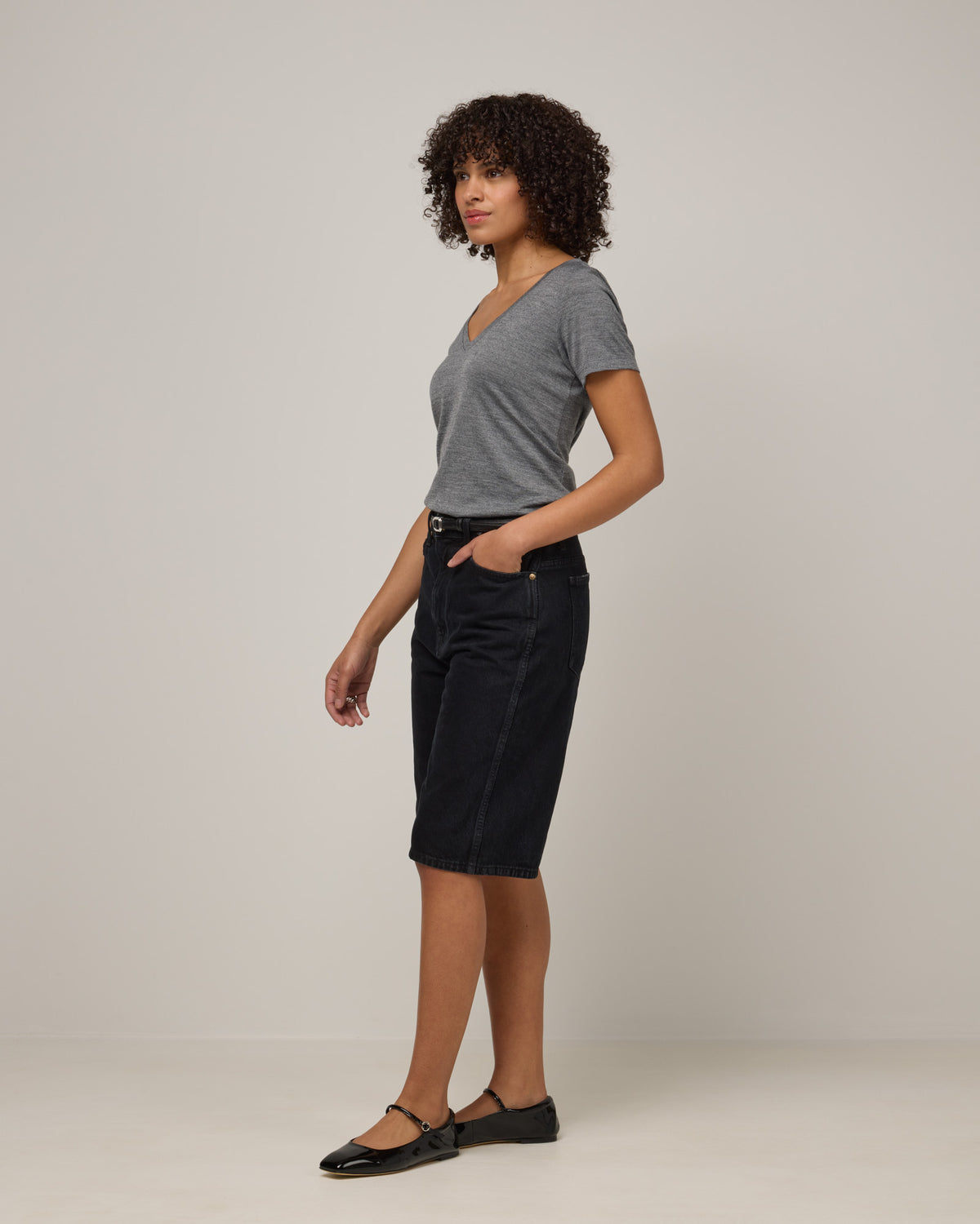 Model wearing Morgan V-Neck Tee in Charcoal Heather. Morgan V-Neck Tee is a merino wool short sleeve, v-neck, regular fit tee available in sizes XS-3X.