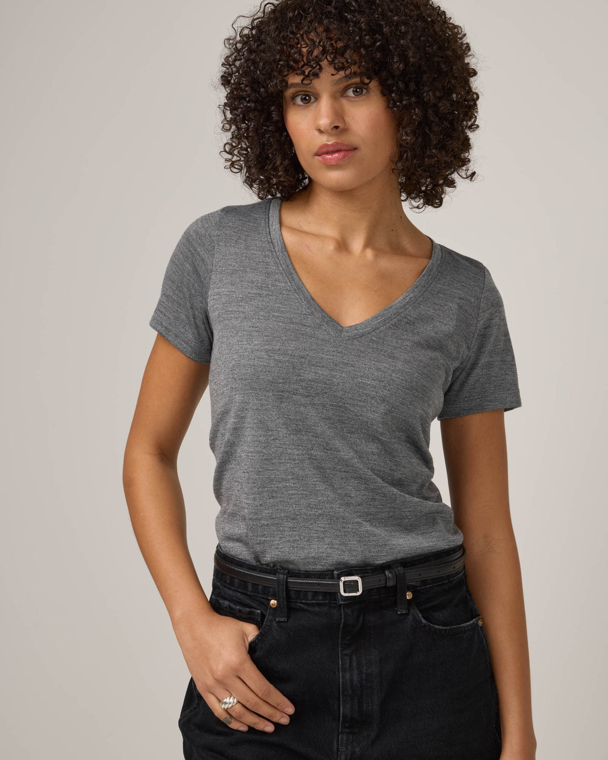 Model wearing Morgan V-Neck Tee in Charcoal Heather. Morgan V-Neck Tee is a merino wool short sleeve, v-neck, regular fit tee available in sizes XS-3X.