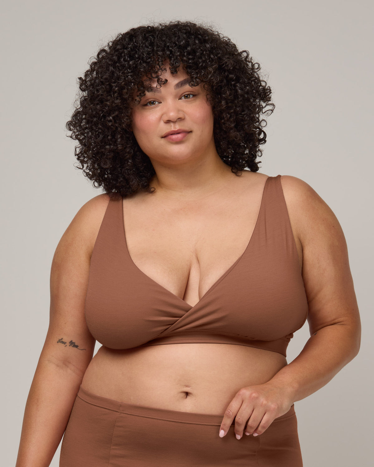 Model wearing Roam Wrap Bra in Mocha Brown, a medium-dark nude color. Roam Wrap Bra is a merino wool underwear available in sizes 1X-3X.