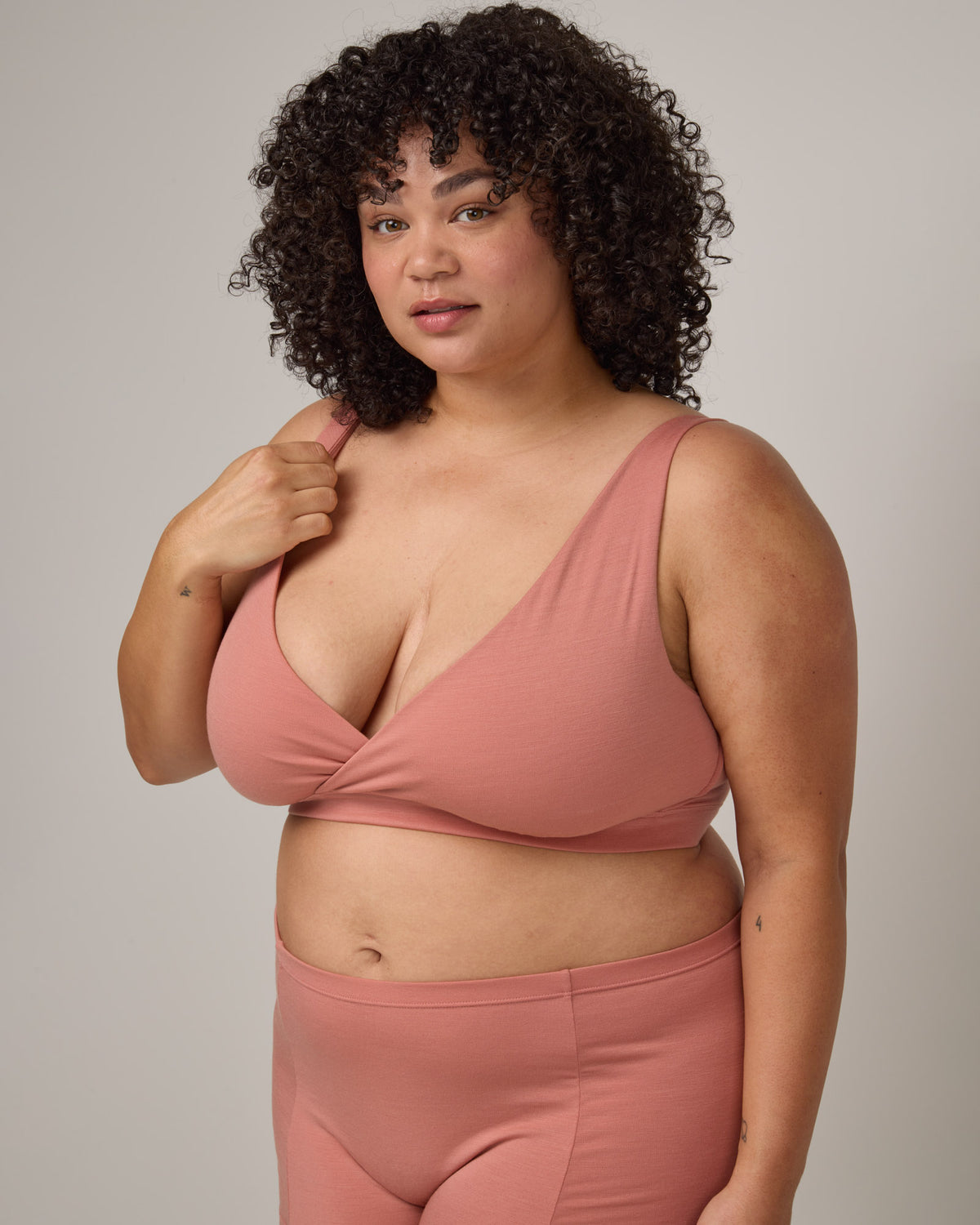 Model wearing Roam Wrap Bra in . Roam Wrap Bra is a merino wool underwear available in sizes 1X-3X.