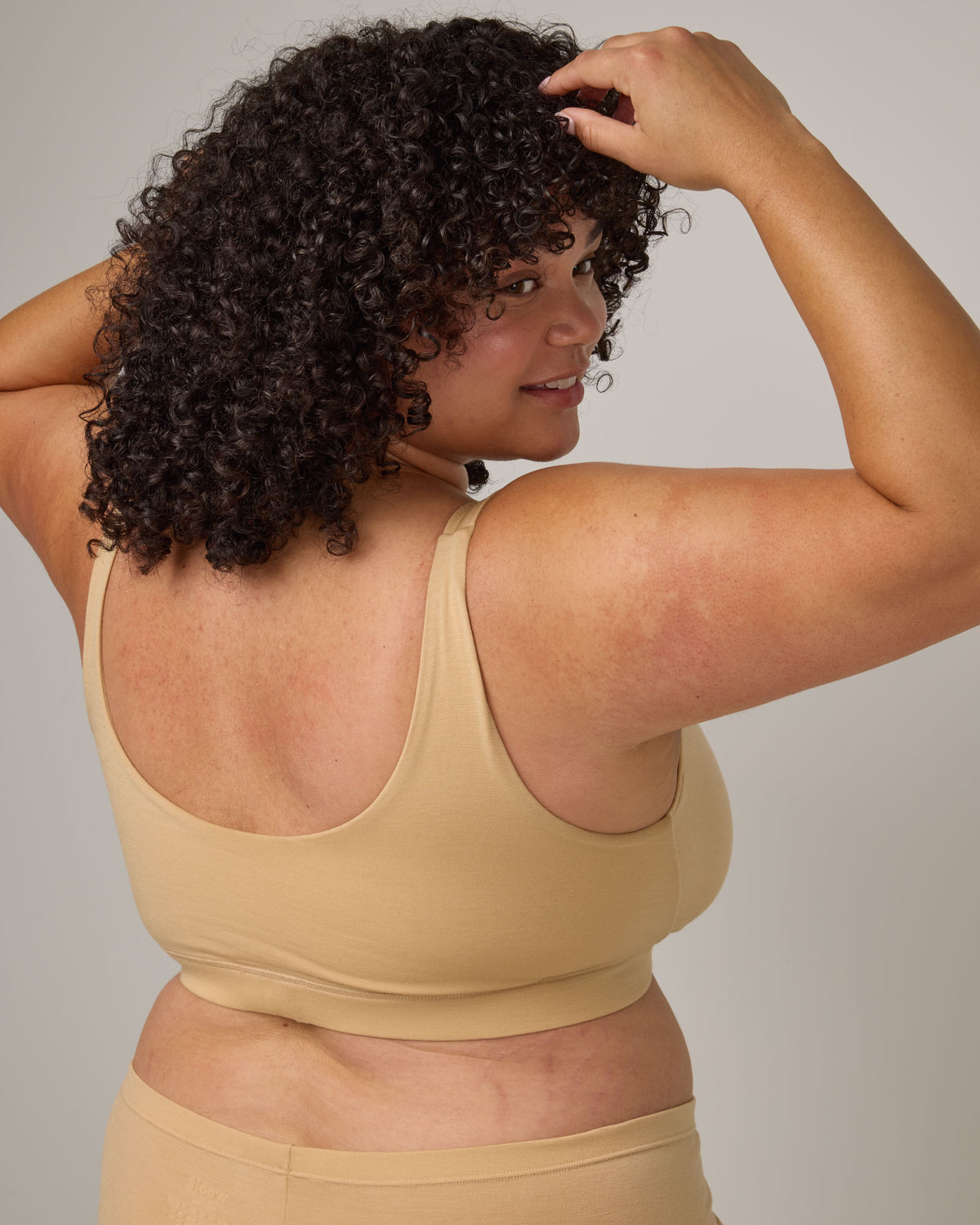 Model wearing Roam Wrap Bra in . Roam Wrap Bra is a merino wool underwear available in sizes 1X-3X.