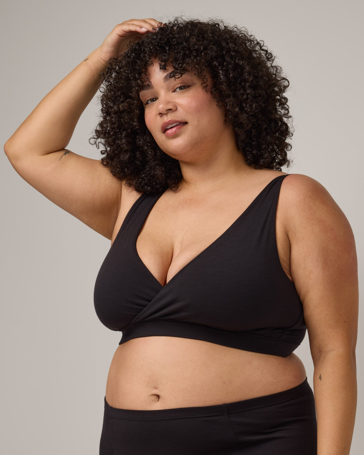 Model wearing Roam Wrap Bra in . Roam Wrap Bra is a merino wool underwear available in sizes 1X-3X.