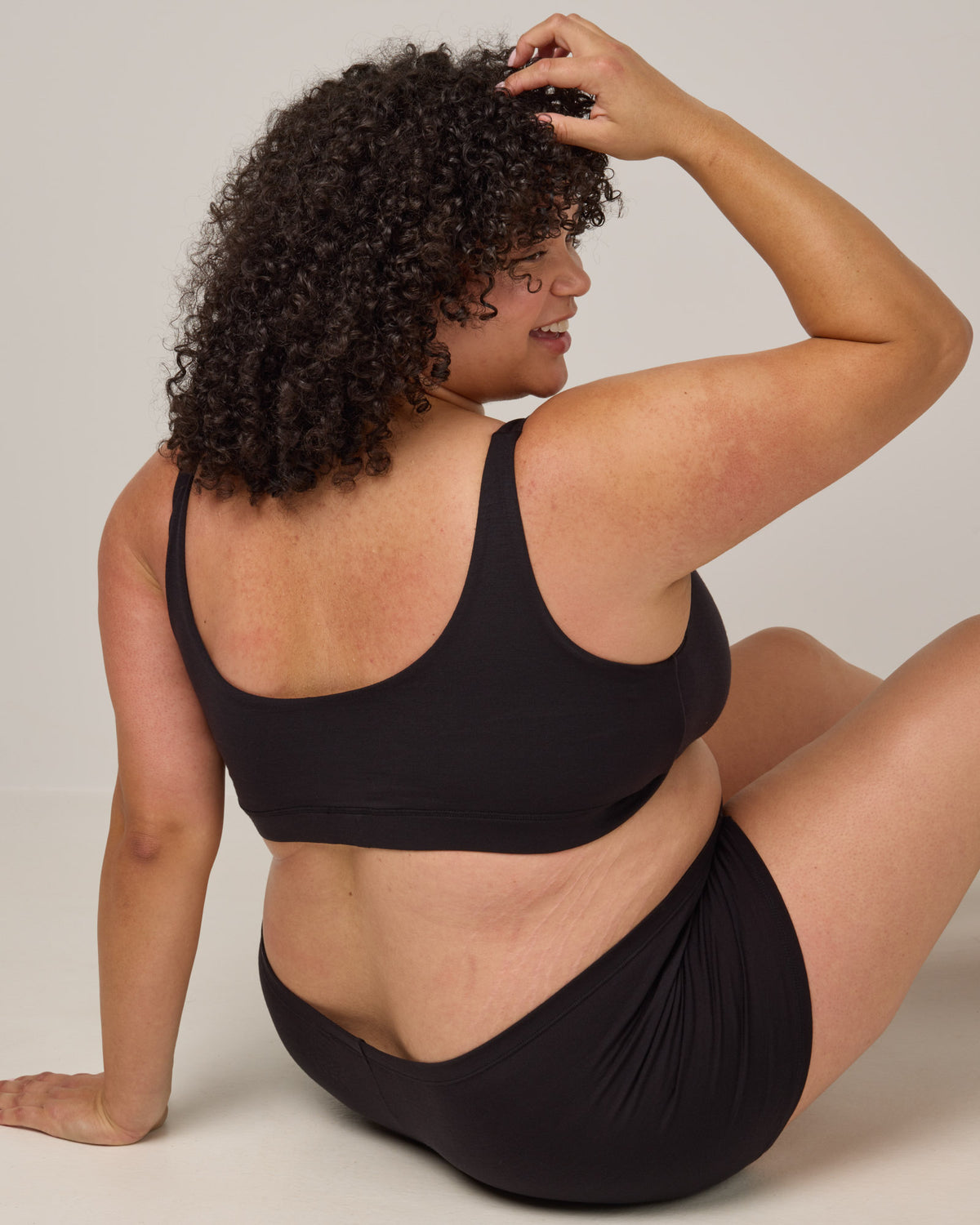 Model wearing Roam Wrap Bra in . Roam Wrap Bra is a merino wool underwear available in sizes 1X-3X.