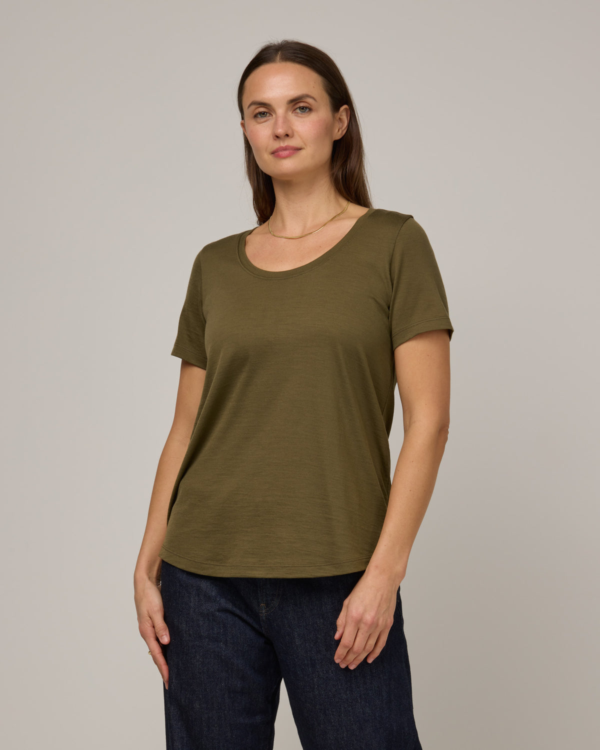 Model wearing Stella Signature Scoop Neck Tee in Olive. Stella Signature Scoop Neck Tee is a merino wool short sleeve, scoop neck, relaxed fit tee available in sizes XS-3X.
