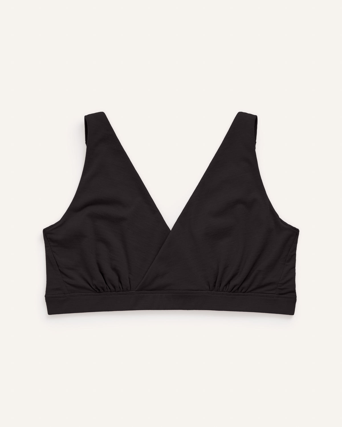 Laydown of Roam Wrap Bra in . Roam Wrap Bra is a merino wool underwear available in sizes 1X-3X.