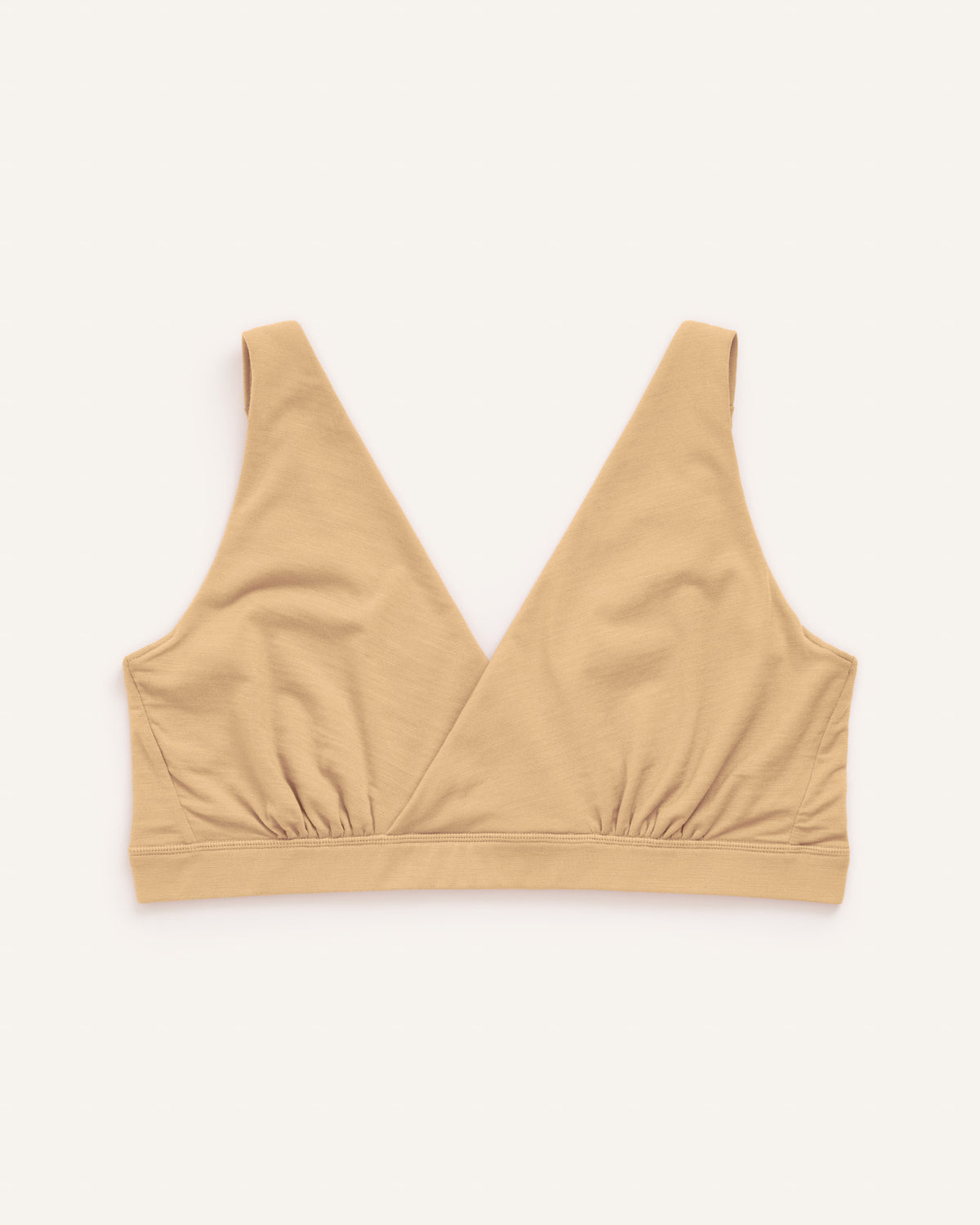 Laydown of Roam Wrap Bra in . Roam Wrap Bra is a merino wool underwear available in sizes 1X-3X.