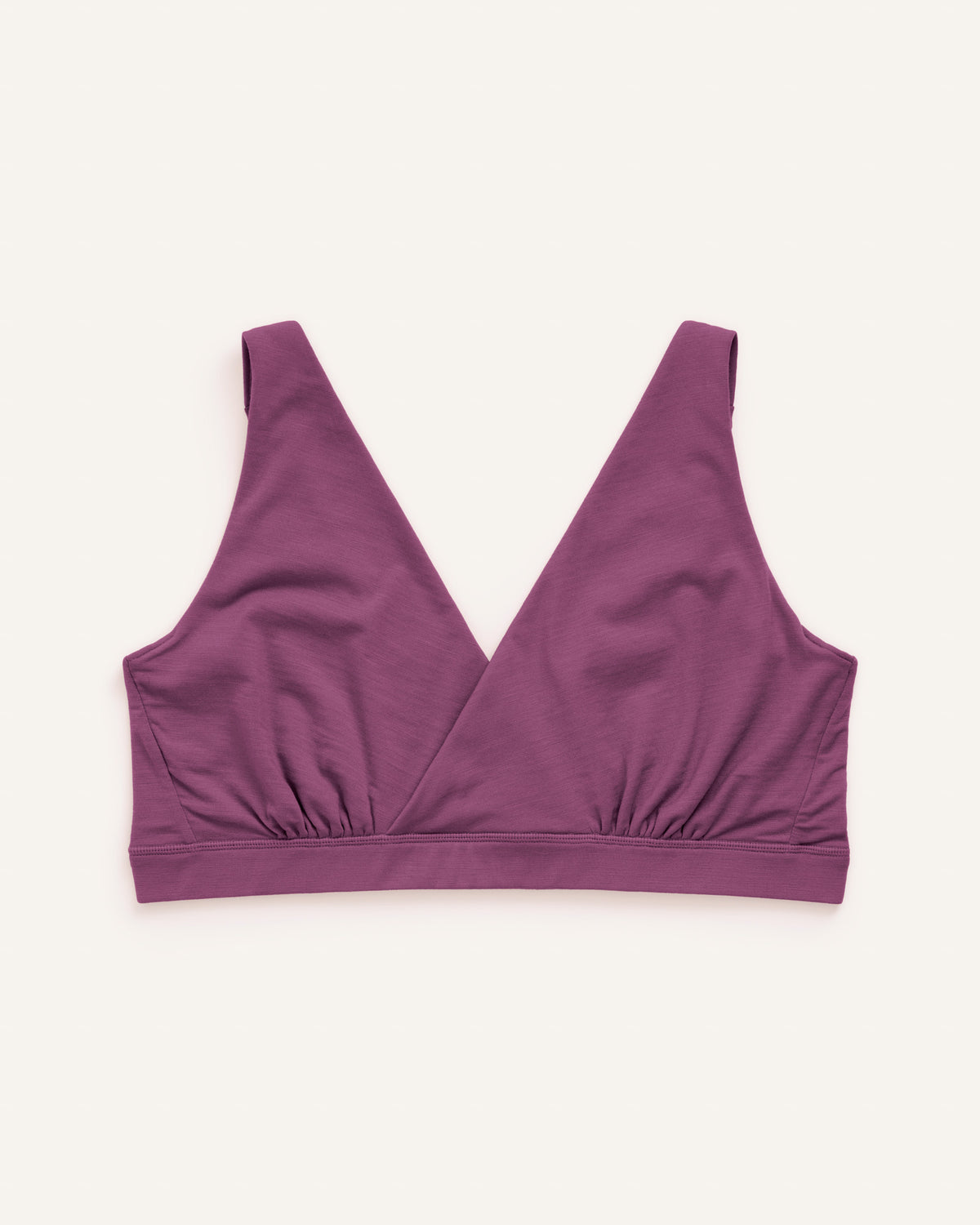 Laydown of Roam Wrap Bra in Plum, a berry pink-purple color. Roam Wrap Bra is a merino wool underwear available in sizes 1X-3X.