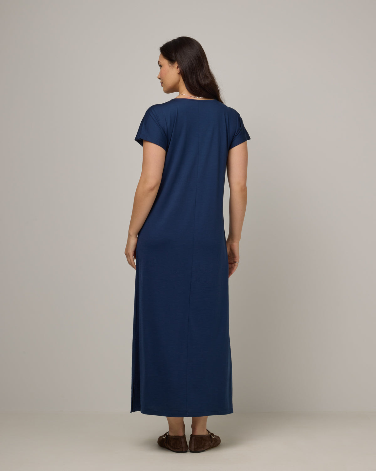 Model wearing Freya Maxi Dress in Marine Blue, a deep royal blue color. Freya Maxi Dress is a merino wool short sleeve, v-neck, maxi swing dress with pockets available in sizes XS-3X.