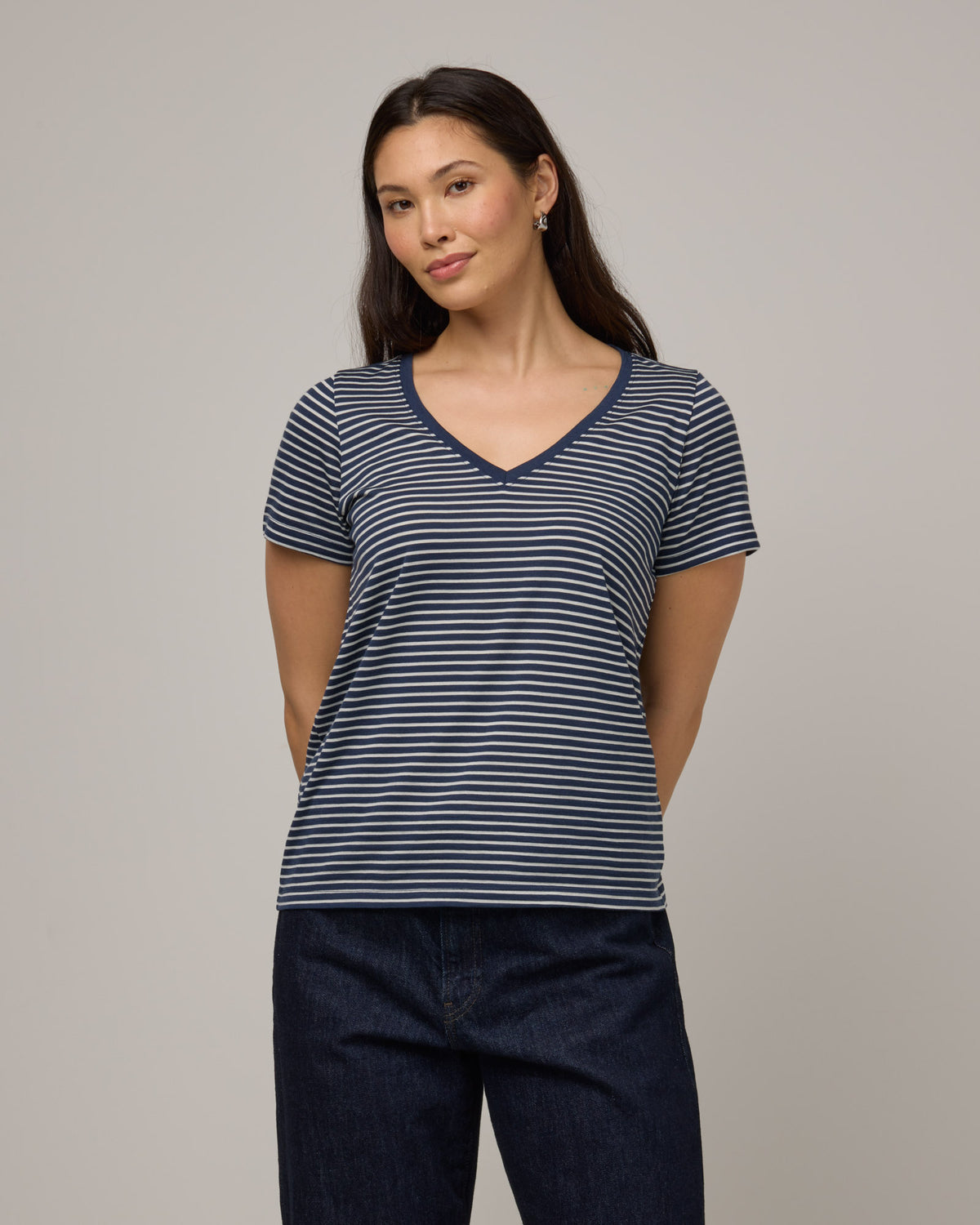 Model wearing Morgan V-Neck Tee in Marine Blue & Natural White Stripe. Morgan V-Neck Tee is a merino wool short sleeve, v-neck, regular fit tee available in sizes XS-3X.