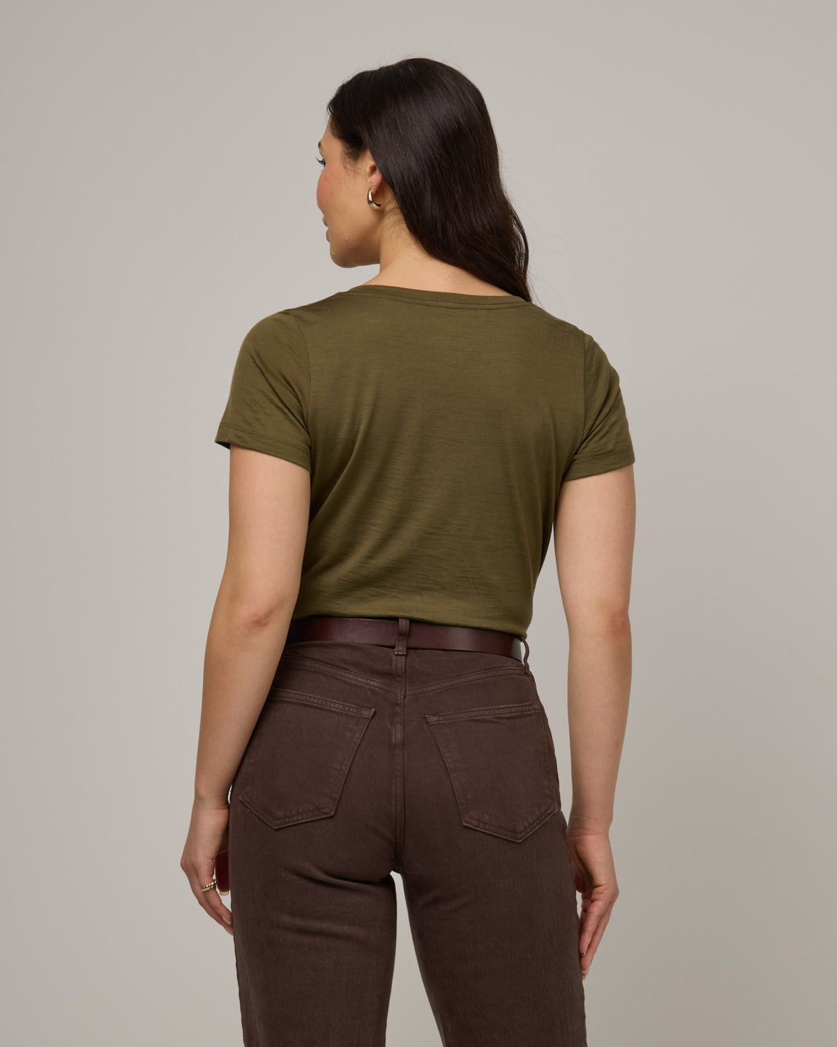 Model wearing Morgan V-Neck Tee in Olive. Morgan V-Neck Tee is a merino wool short sleeve, v-neck, regular fit tee available in sizes XS-3X.
