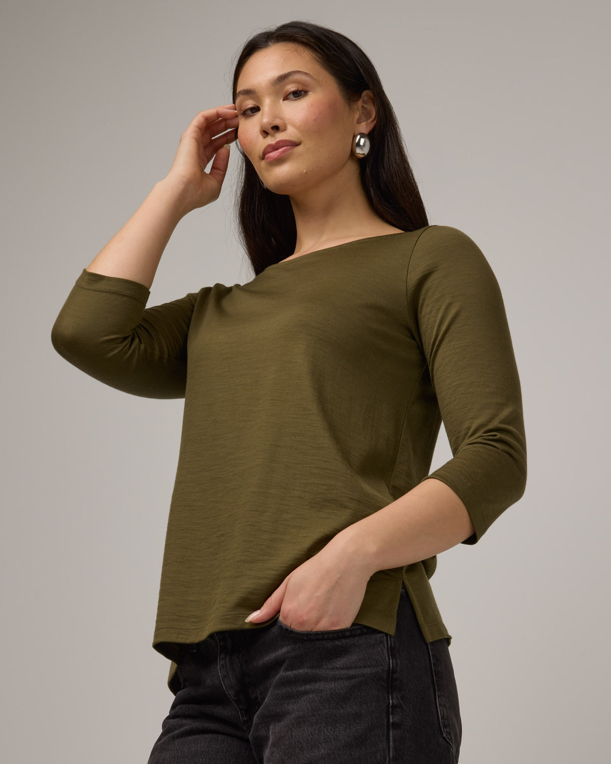 Model wearing Colette Quarter-Sleeve Top in Olive. Colette Quarter-Sleeve Top is a merino wool long sleeve, boatneck, regular fit top available in sizes XS-3X.