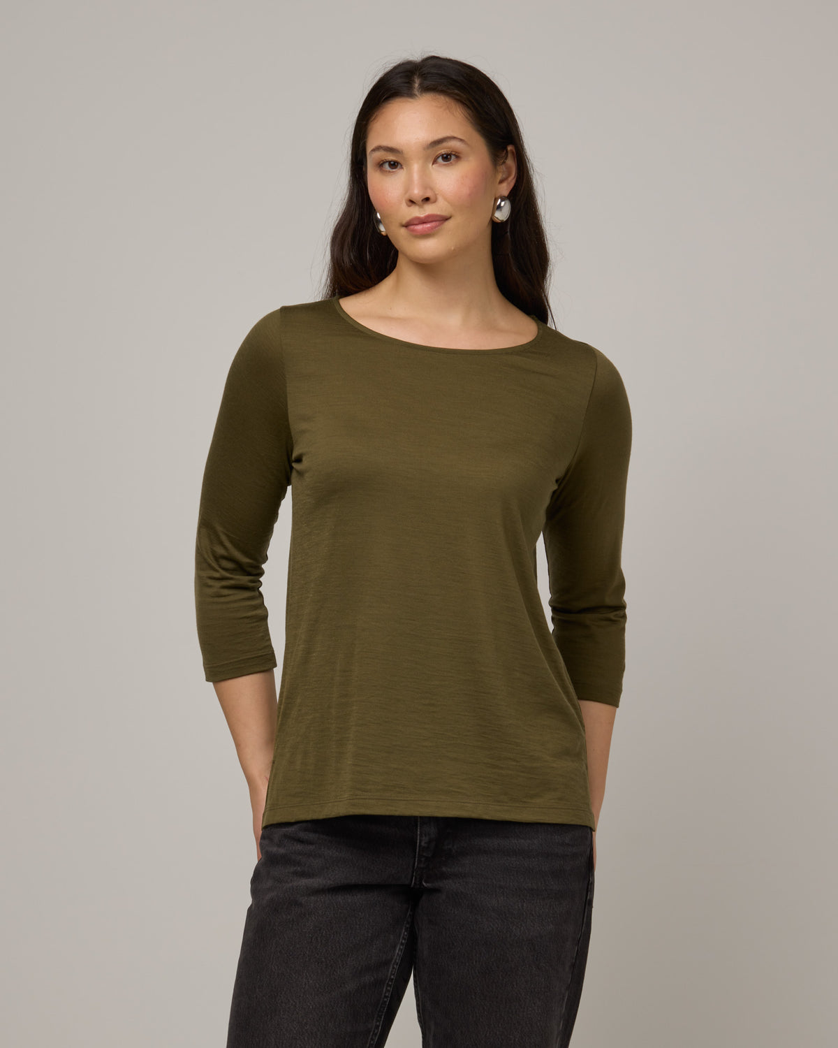 Model wearing Colette Quarter-Sleeve Top in Olive. Colette Quarter-Sleeve Top is a merino wool long sleeve, boatneck, regular fit top available in sizes XS-3X.