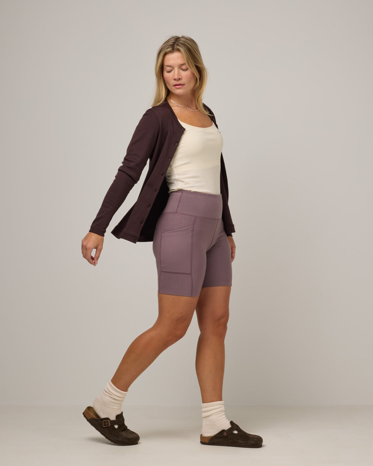 Model wearing Summit Pocket Bike Short in Lavender, a dusky muted purple color. Summit Pocket Bike Short is a merino wool short with pockets available in sizes XS-3X.