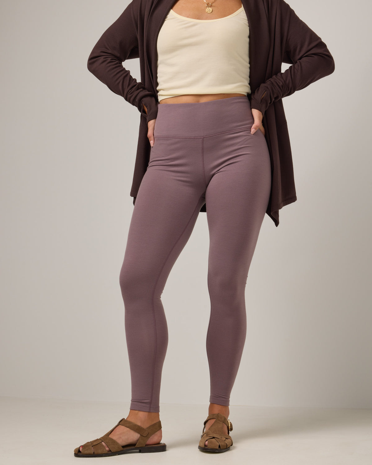 Model wearing Summit Legging in Lavender, a dusky muted purple color. Summit Legging is a merino wool legging available in sizes XS-3X.