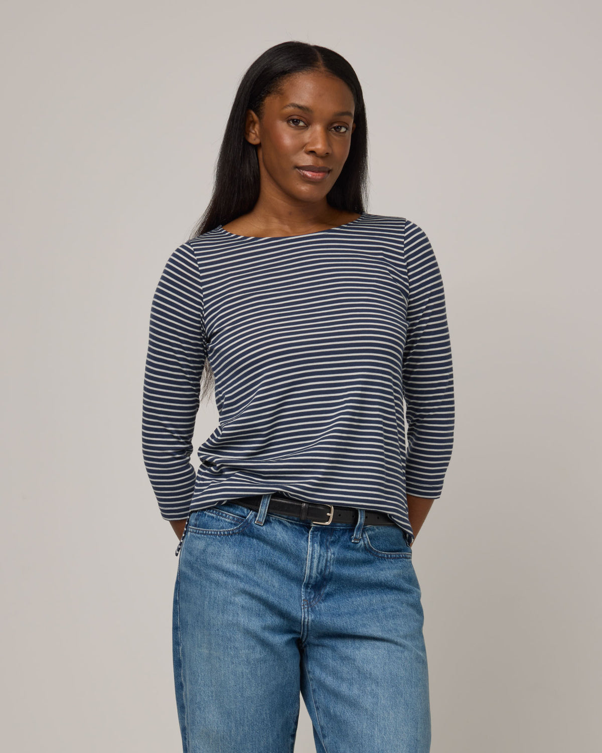 Model wearing Colette Quarter-Sleeve Top in Marine Blue & Natural White Stripe. Colette Quarter-Sleeve Top is a merino wool long sleeve, boatneck, regular fit top available in sizes XS-3X.