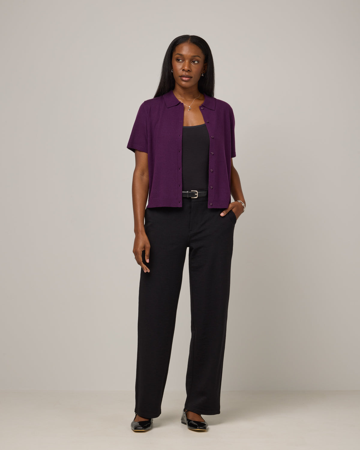 Model wearing Carson Ponte Trouser in Black. Carson Ponte Trouser is a merino wool pant with pockets available in sizes XS-3X Regular, XS-XL Petite.