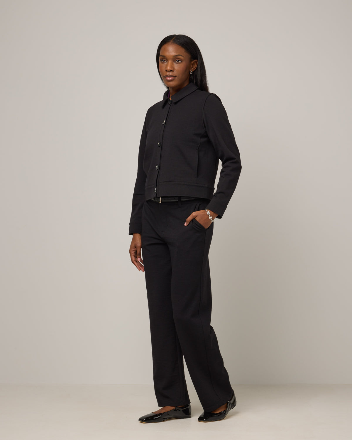 Model wearing Johnny Ponte Jacket in Black. Johnny Ponte Jacket is a merino wool long sleeve, collared, jacket with pockets available in sizes XS-XXL.