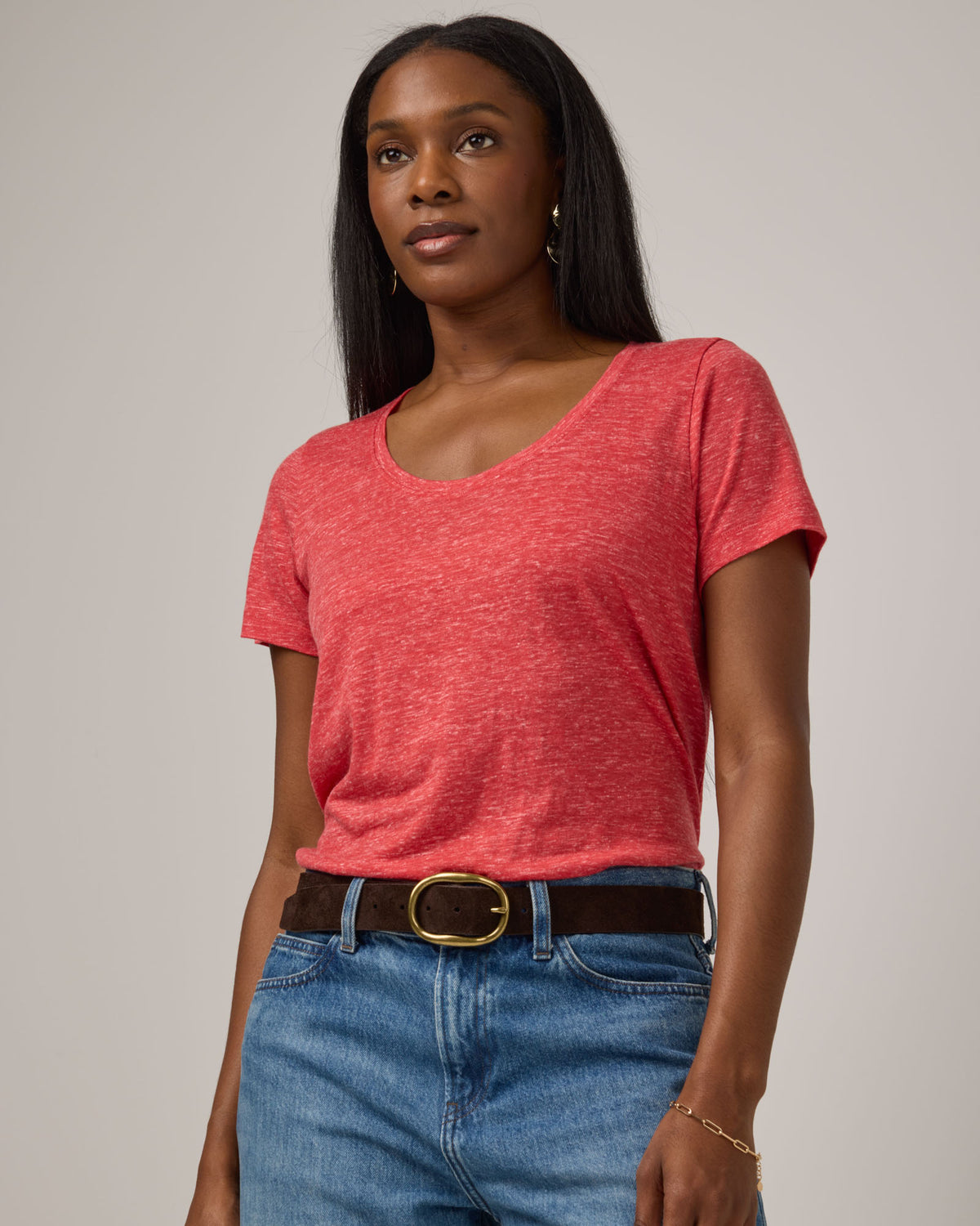 Model wearing Stella Linen Scoop Neck Tee in Fruit Punch, a vivid red-orange color. Stella Linen Scoop Neck Tee is a merino wool short sleeve, scoop neck, relaxed fit tee available in sizes XS-3X.
