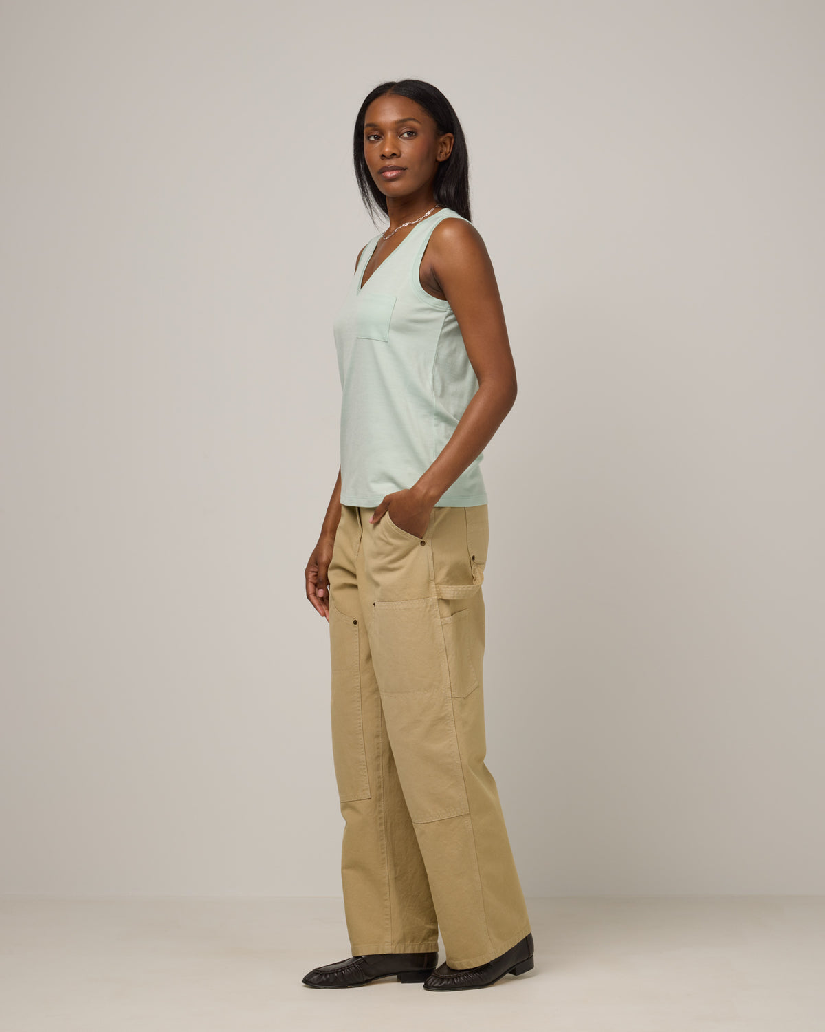 Model wearing Penelope Pocket Tank in Morning Dew, a light mint green color. Penelope Pocket Tank is a merino wool sleeveless, v-neck tank with a pocket available in sizes XS-3X.