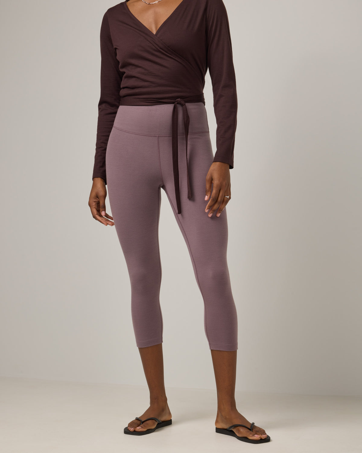 Model wearing Summit Crop Legging in Lavender, a dusky muted purple color. Summit Crop Legging is a merino wool legging available in sizes XS-3X.