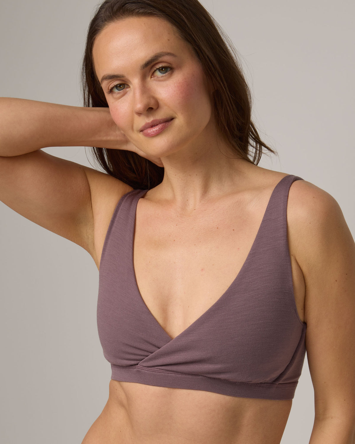 Model wearing Roam Convertible Wrap Bra in Lavender, a dusky, muted purple color. Roam Convertible Wrap Bra is a merino wool underwear available in sizes XS-XXL.