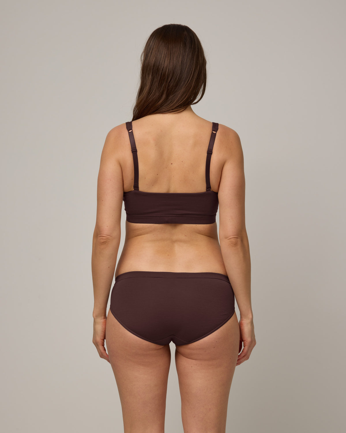 Model wearing Roam Bikini in Espresso, a dark brown color. Roam Bikini is a merino wool underwear available in sizes XS-3X.