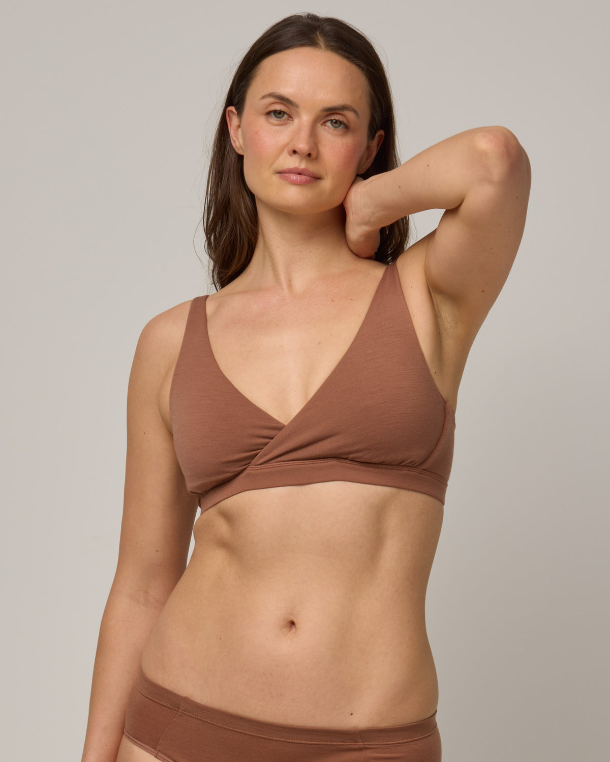 Model wearing Roam Convertible Wrap Bra in Mocha Brown, a medium-dark nude color. Roam Convertible Wrap Bra is a merino wool underwear available in sizes XS-XXL.