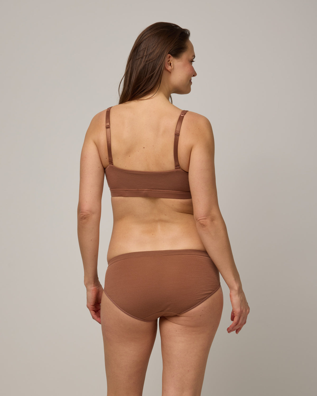Model wearing Roam Convertible Wrap Bra and Bikini underwear set in Mocha Brown, a medium-dark nude color.