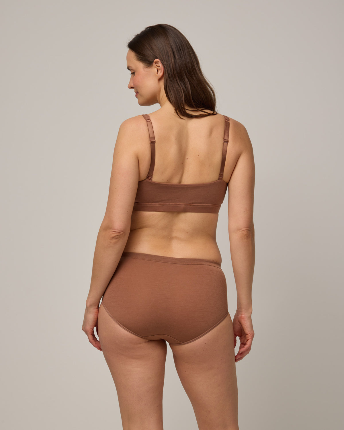 Model wearing Roam High Waist Bikini & Convertible Wrap Bra in Mocha Brown, a medium-dark nude color. Roam High Waist Bikini is a merino wool underwear available in sizes XS-3X.