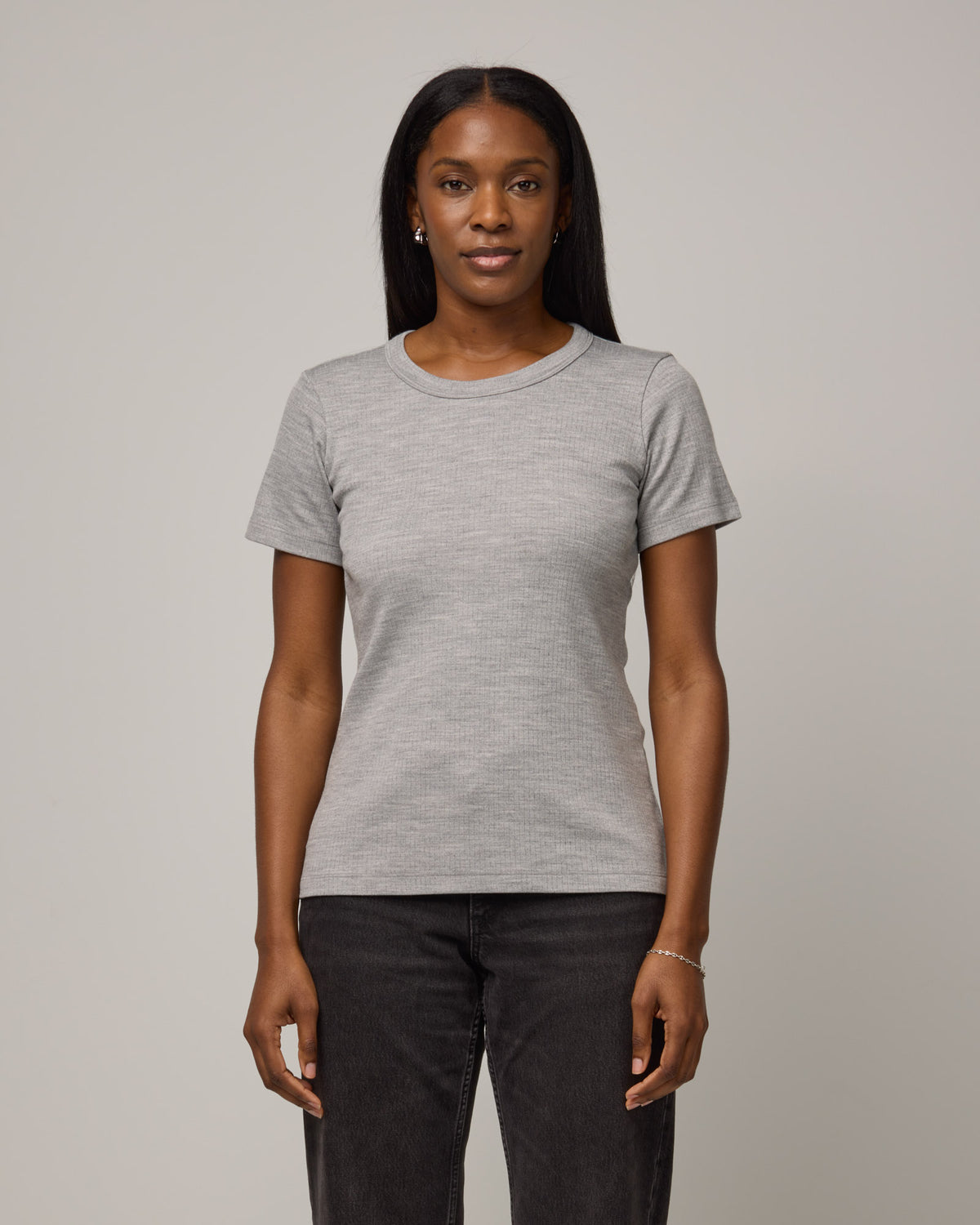 Model wearing Taylor Ribbed Tee in Gray Heather. Taylor Ribbed Tee is a merino wool short sleeve crew neck tee available in sizes XS-3X.