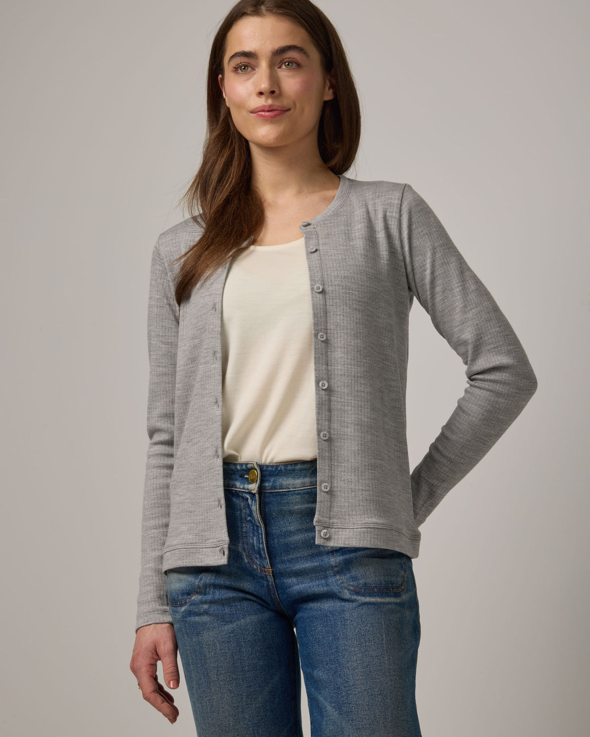 Model wearing Celeste Ribbed Cardigan in Gray Heather. Celeste Ribbed Cardigan is a merino wool long sleeve, crew neck cardigan available in sizes XS-3X.