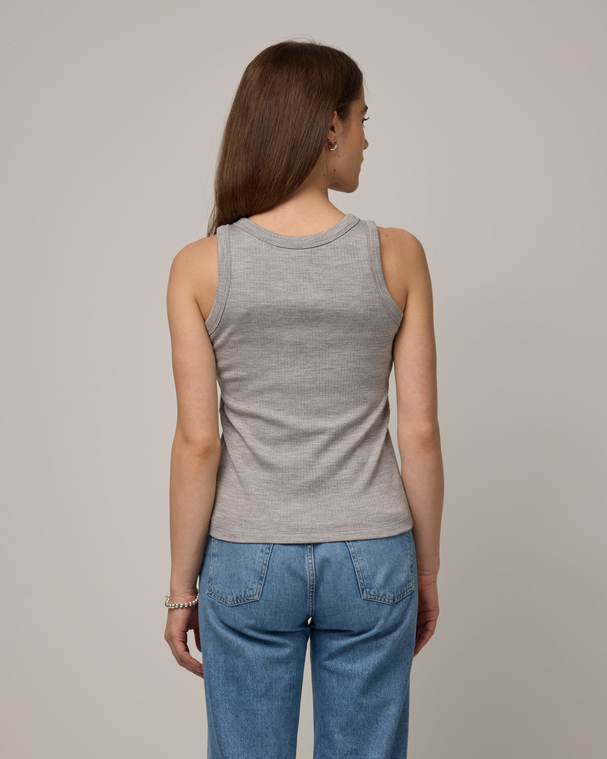 Model wearing Lily Ribbed Tee in Gray Heather. Lily Ribbed Tee is a merino wool sleeveless, crew neck tank available in sizes XS-3X. 