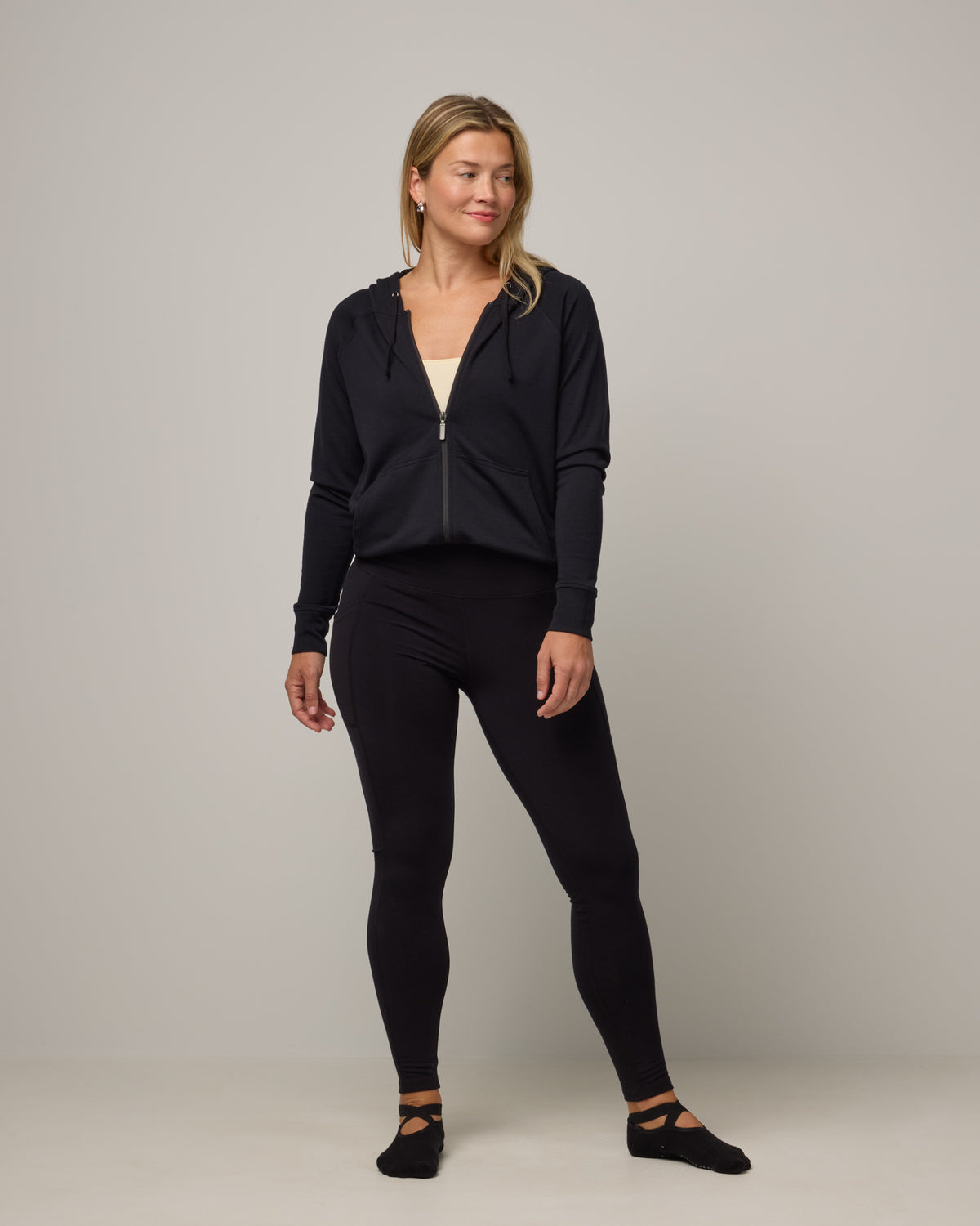 Model wearing Summit Pocket Legging in Black. Summit Pocket Legging is a merino wool legging with pockets available in sizes XS-3X Regular, S-XXL Long.