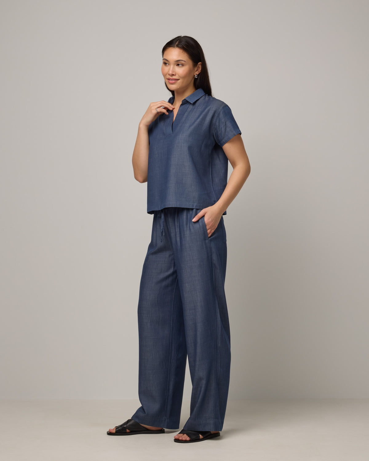 Model wearing Erin Chambray Pant in Dark Blue. Erin Chambray Pant is a merino wool drawstring easy pant available in sizes XS-XXL. 
