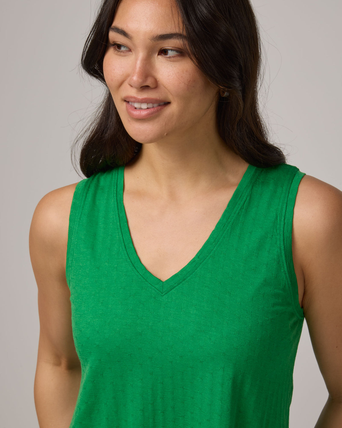 Model wearing Poppy Jacquard Reversible Tank in Verde, a bright Kelly green color. Poppy Signature Reversible Tank is a merino wool sleeveless, reversible, relaxed fit top available in sizes XS-3X.
