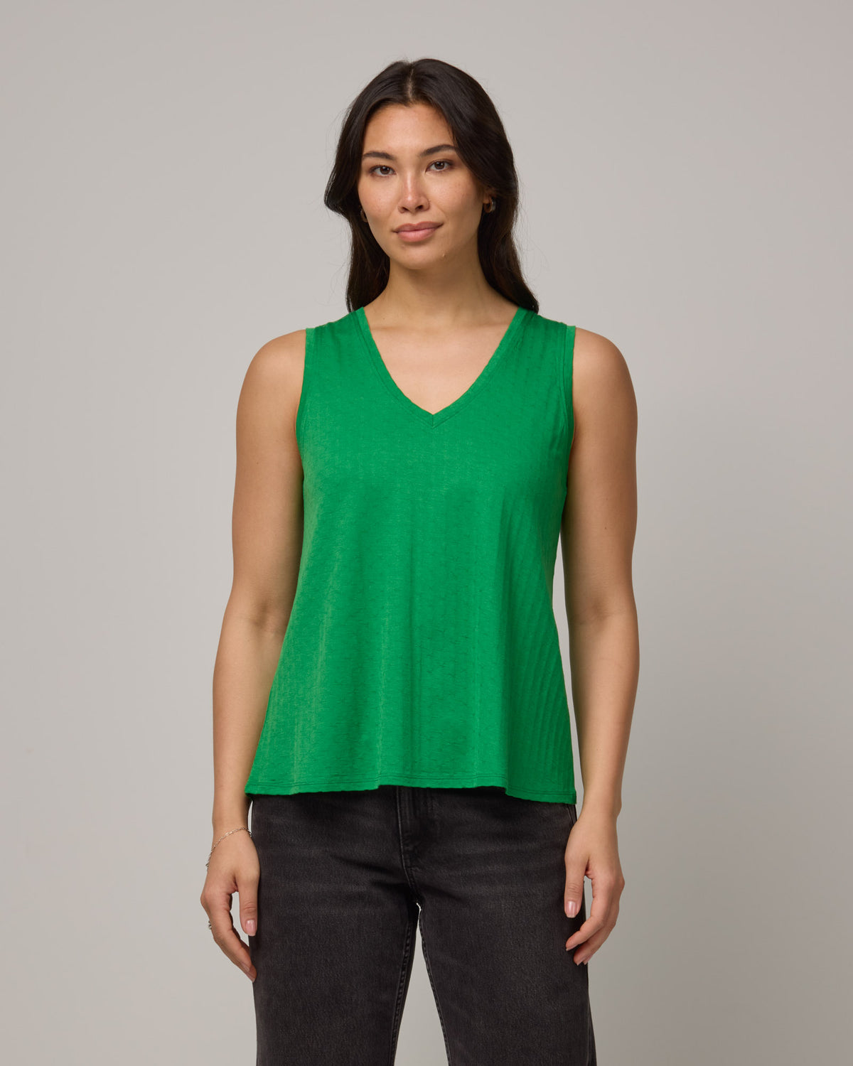 Model wearing Poppy Jacquard Reversible Tank in Verde, a bright Kelly green color. Poppy Signature Reversible Tank is a merino wool sleeveless, reversible, relaxed fit top available in sizes XS-3X.