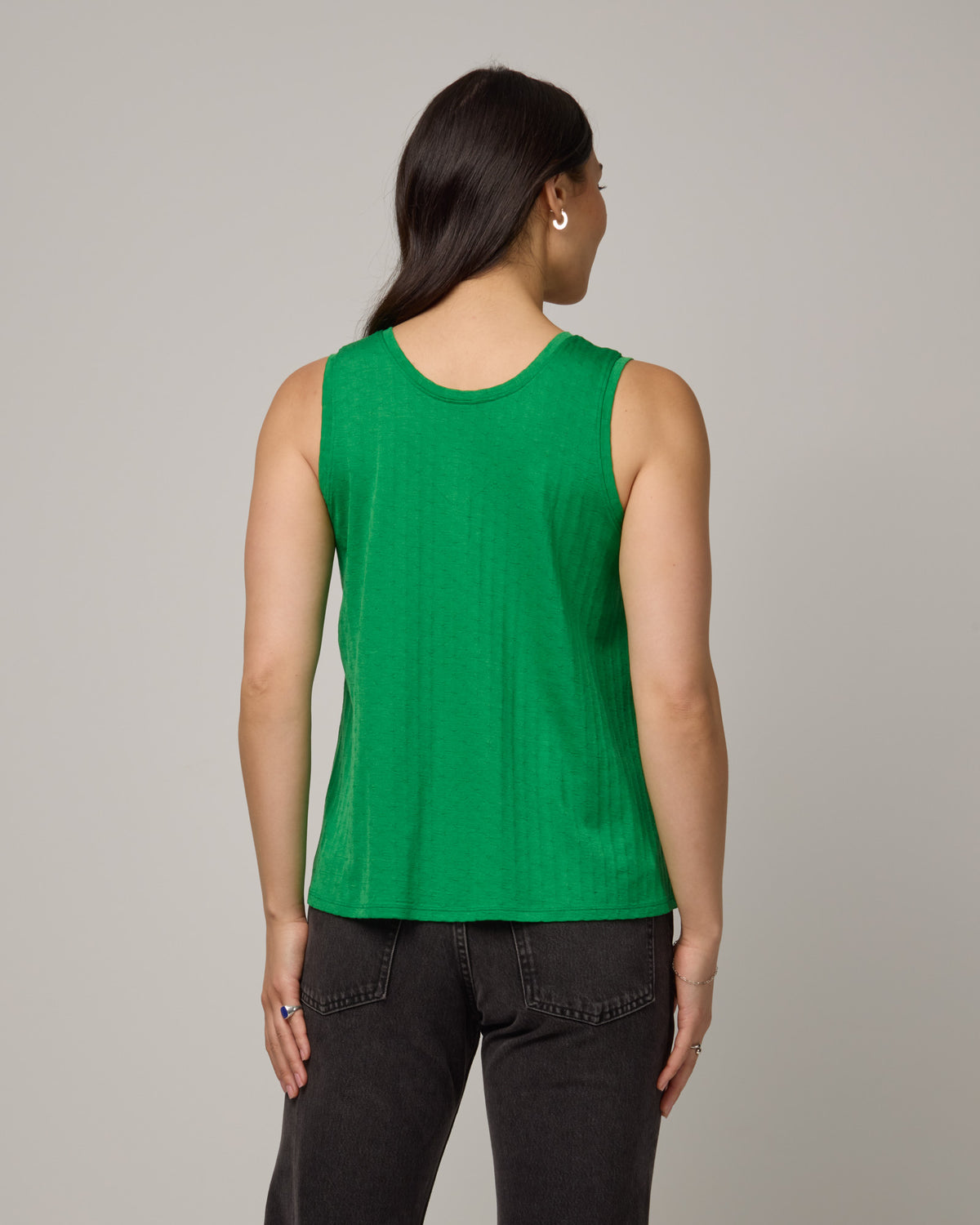 Model wearing Poppy Jacquard Reversible Tank in Verde, a bright Kelly green color. Poppy Signature Reversible Tank is a merino wool sleeveless, reversible, relaxed fit top available in sizes XS-3X.