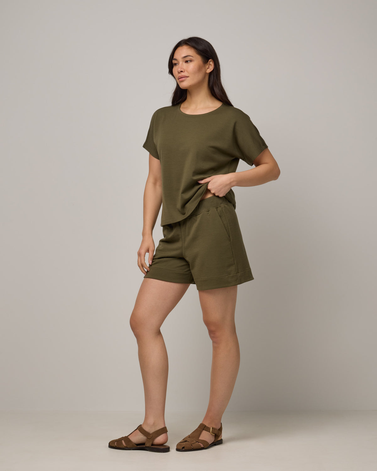 Model wearing Aspen Short in Olive. Aspen Short is a merino wool sweat short with 5in inseam available in sizes XS-XXL.