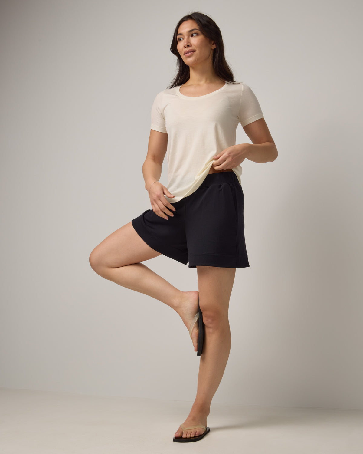 Model wearing Aspen Short in Black. Aspen Short is a merino wool sweat short with 5in inseam available in sizes XS-XXL.