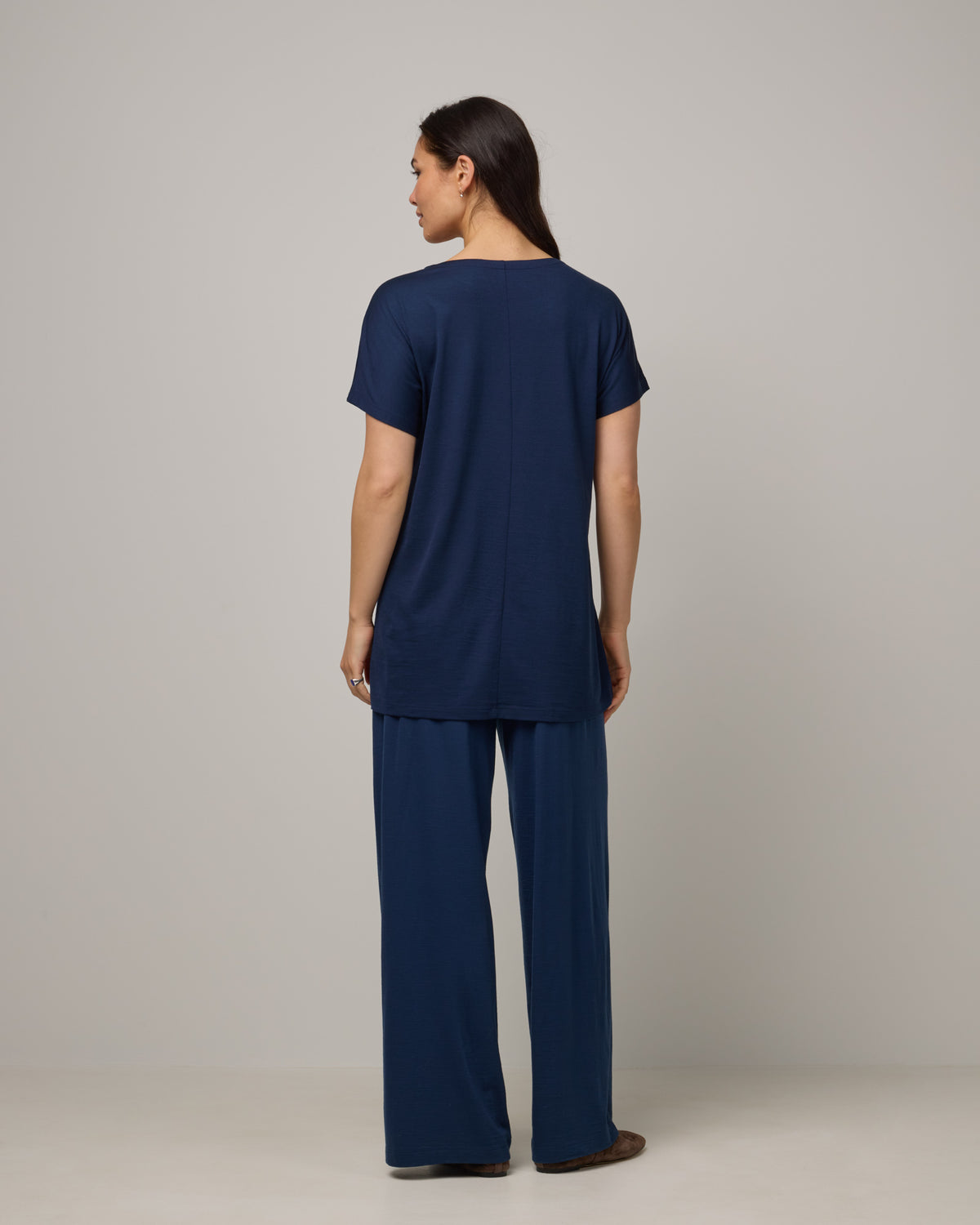 Model wearing Jade Tunic Tee in Marine Blue, a deep royal blue color. Jade Tunic Tee is a merino wool short sleeve, crew neck, relaxed fit tunic available in sizes XS-3X.