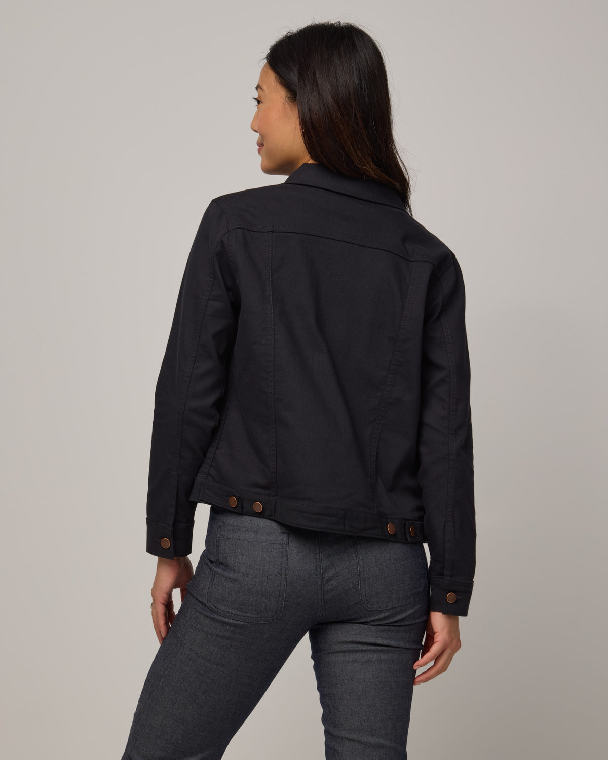 Model wearing Logan Denim Jacket in Black. Logan Denim Jacket is a merino wool classic long sleeve, collared denim jacket available in sizes XS-XXL.