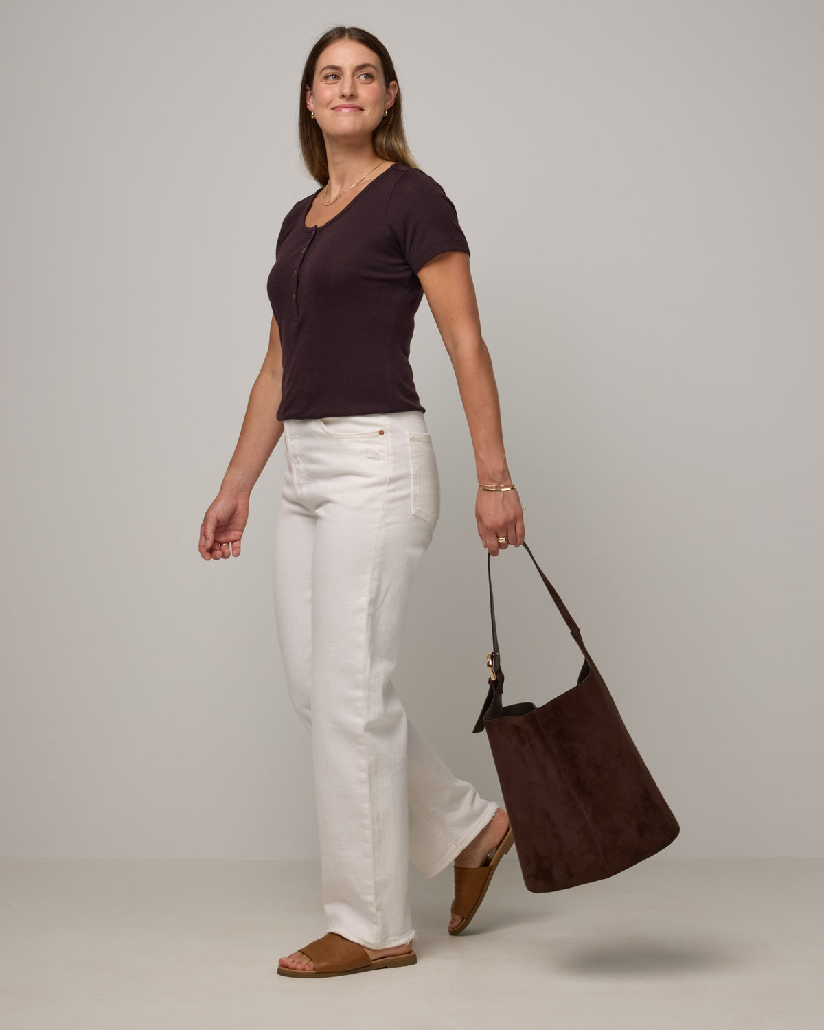 Model wearing Marie Pointelle Henley in Espresso, a dark brown color. Marie Pointelle Henley is a short sleeve, scoop neck, fitted top available in sizes XS-3X. 